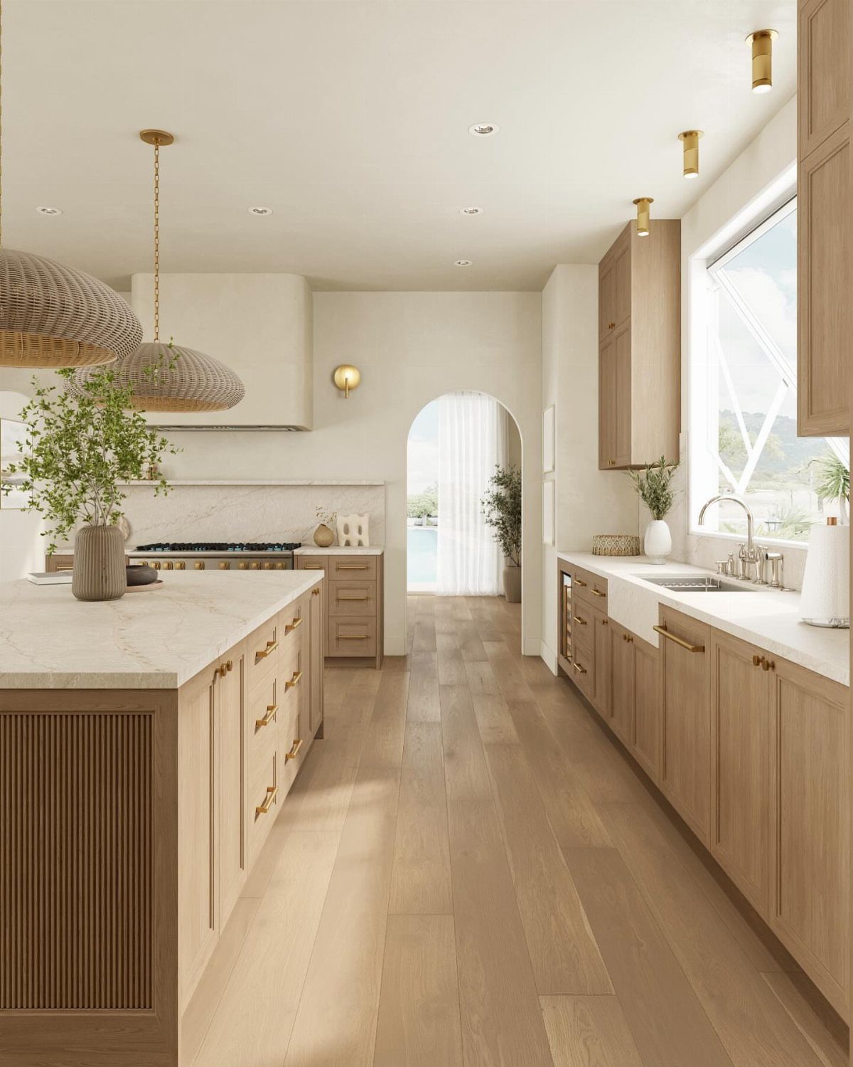 Light natural wood kitchen cabinets with white marble countertops and matching wood floors.